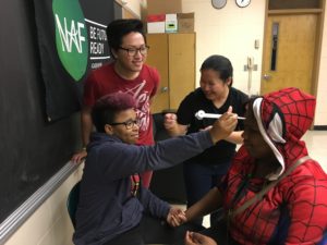 Youth Health Service Corps (YHSC) members perform neurological tests, guided by peer assistants or experienced members of YHSC.