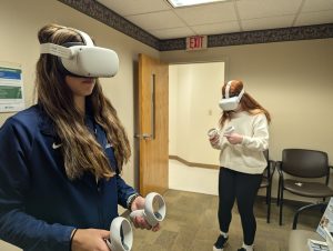 Two students test virtual reality headsets