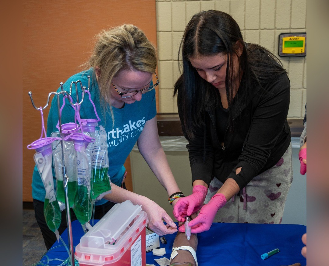 Two women work with IV bags