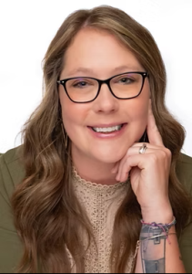 A woman with glasses and long light-brown hair smiling