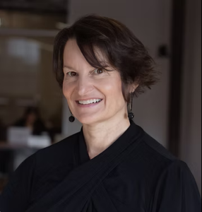 A woman with short dark hair in a black shirt