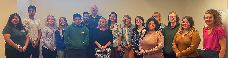 A group of health care students, professionals and AHEC staff pose for a group photo after an educational experience. 
